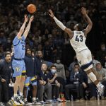 
              Marquette guard Tyler Kolek (22) takes a three point shot over Villanova forward Eric Dixon (43) during the second half of an NCAA college basketball game, Wednesday, Jan. 19, 2022, in Villanova, Pa. (AP Photo/Laurence Kesterson)
            