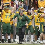 
              North Dakota State guard Brandon Westberg (77) and other players celebrate after head coach Matt Entz runs away after he was doused during the final moments of the FCS Championship NCAA college football game against Montana State, Saturday, Jan. 8, 2022, in Frisco, Texas.  (AP Photo/Michael Ainsworth)
            
