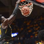 
              Baylor forward Jonathan Tchamwa Tchatchoua (23) dunks the ball while being guarded by West Virginia guard Taz Sherman (12) during the second half of an NCAA college basketball game in Morgantown, W.Va., Tuesday, Jan. 18, 2022. (William Wotring)
            