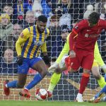 
              Liverpool's Roberto Firmino, center, scores his side's third goal during the English FA Cup third round soccer match between Liverpool and Shrewsbury Town at Anfield stadium in Liverpool, Sunday, Jan. 9, 2022. (AP Photo/Jon Super)
            