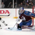 
              Los Angeles Kings left wing Alex Iafallo, left, attempts to score on Colorado Avalanche goaltender Darcy Kuemper during the second period of an NHL hockey game Thursday, Jan. 20, 2022, in Los Angeles. (AP Photo/Mark J. Terrill)
            