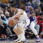 
              Denver Nuggets guard Facundo Campazzo, front, is defended by Sacramento Kings guard Davion Mitchell during the first half of an NBA basketball game Friday, Jan. 7, 2022, in Denver. (AP Photo/David Zalubowski)
            