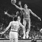
              FILE - Philadelphia's Julius Erving (6) goes to the basket past Milwaukee's Sidney Moncrief and Brian Winters (32) during first quarter playoff action at Milwaukee, May 2, 1982. (AP Photo/Steve Pyle, File)
            