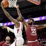 
              Arkansas guard Davonte Davis (4) drives past South Carolina forward Ta'Quan Woodley (55) to score during the first half of an NCAA college basketball game Tuesday, Jan. 18, 2022, in Fayetteville, Ark. (AP Photo/Michael Woods)
            