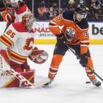 
              Calgary Flames' goalie Jacob Markstrom (25) makes a save on Edmonton Oilers' Warren Foegele (37) during the second period of an NHL hockey game Saturday, Jan. 22, 2022, in Edmonton, Alberta. (Jason Franson/The Canadian Press via AP)
            