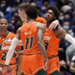 
              Miami guards Jordan Miller (11) and Kameron McGusty celebrate with Charlie Moore (3), Isaiah Wong (2) and forward Sam Waardenburg during the second half of the team's NCAA college basketball game against Duke in Durham, N.C., Saturday, Jan. 8, 2022. (AP Photo/Gerry Broome)
            