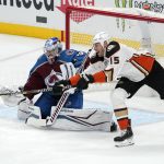 
              Anaheim Ducks center Ryan Getzlaf, right, tries to redirect a shot as Colorado Avalanche goaltender Pavel Francouz sits in goal during the first period of an NHL hockey game Wednesday, Jan. 19, 2022, in Anaheim, Calif. (AP Photo/Mark J. Terrill)
            