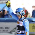 
              Italy's Elena Curtoni celebrates in the finish area of an alpine ski, women's World Cup super-G race in Cortina d'Ampezzo, Italy, Sunday, Jan. 23, 2022. (AP Photo/Alessandro Trovati)
            