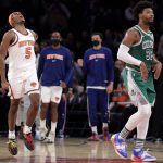 
              New York Knicks guard Immanuel Quickley (5) reacts after making a basket as Boston Celtics guard Marcus Smart, right, walks to his bench during the second half of an NBA basketball game Thursday, Jan. 6, 2022, in New York. (AP Photo/Adam Hunger)
            