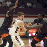 
              Virginia Tech's Sean Pedulla (3) protects the ball while defended by Miami's Anthony Walker (1) left, and Bensley Joseph (4)  during the first half of an NCAA college basketball game, Wednesday, Jan. 26 2022, in Blacksburg Va. (Matt Gentry/The Roanoke Times via AP)
            