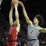 
              Texas Tech guard Clarence Nadolny scores past Baylor guard Kendall Brown during the first half of an NCAA college basketball game Tuesday, Jan. 11, 2022, in Waco, Texas. (AP Photo/Jerry Larson)
            