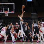 
              The San Antonio Spurs and Toronto Raptors go for a jump ball during the first half of an NBA basketball game Tuesday, Jan. 4, 2022, in Toronto, in an arena with no fans in attendance. (Frank Gunn/The Canadian Press via AP)
            