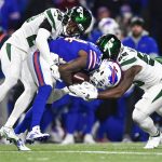 
              New York Jets Brandin Echols, left, and Quincy Williams, right, tackle Buffalo Bills' Stefon Diggs, center, during the first half of an NFL football game, Sunday, Jan. 9, 2022, in Orchard Park, N.Y. (AP Photo/Adrian Kraus)
            