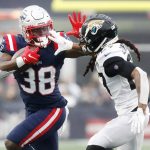 
              New England Patriots running back Rhamondre Stevenson (38) tries to break free from Jacksonville Jaguars cornerback Chris Claybrooks, right, during the first half of an NFL football game, Sunday, Jan. 2, 2022, in Foxborough, Mass. (AP Photo/Paul Connors)
            