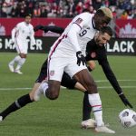 
              Canada's Steven Vitoria, right,  and United States' Gyasi Zardes (9) vie for the ball during the first half of a World Cup soccer qualifier in Hamilton, Ontario, Sunday, Jan. 30, 2022. (Frank Gunn/The Canadian Press via AP)
            
