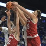 
              Indiana's Miller Kopp (12) and Race Thompson (25) battle for a rebound with Penn State's Greg Lee (5) and John Harrar (21) during an NCAA college basketball game Sunday, Jan 2, 2022, in State College, Pa. (AP Photo/Gary M. Baranec)
            