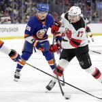 
              New Jersey Devils center Yegor Sharangovich (17) shoots and scores a goal in front of New York Islanders right wing Oliver Wahlstrom (26) in the first period of an NHL hockey game Thursday, Jan. 13, 2022, in Elmont, N.Y. (AP Photo/Adam Hunger)
            