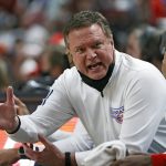 
              Kansas coach Bill Self talks to his team on the bench during the first half of an NCAA college basketball game against Texas Tech, Saturday, Jan. 8, 2022, in Lubbock, Texas. (AP Photo/Brad Tollefson)
            