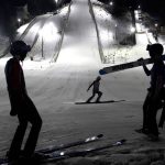 
              Jacob Fuller, left, and Isak Nichols, right, watch Shane Kocher finish his last jump of the night off the 70-meter ski jump Tuesday, Jan. 18, 2022, at the Norge Ski Club in Fox River Grove, Ill. Three men will represent the club for a second straight Winter Olympics. (AP Photo/Charles Rex Arbogast)
            