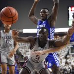 
              Texas A&M guard Hassan Diarra (5) and Kentucky guard Kellan Grady (31) chase the ball during the first half of an NCAA college basketball game Wednesday, Jan. 19, 2022, in College Station, Texas. (AP Photo/Justin Rex)
            