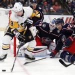 
              Pittsburgh Penguins forward Evan Rodrigues, left, reaches for the puck in front of Columbus Blue Jackets goalie Joonas Korpisalo, center, and defenseman Jake Bean during the first period of an NHL hockey game in Columbus, Ohio, Friday, Jan. 21, 2022. (AP Photo/Paul Vernon)
            