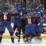 
              Colorado Avalanche players celebrate with defenseman Cale Makar after his power-play goal in overtime of an NHL hockey game against the Boston Bruins Wednesday, Jan. 26, 2022, in Denver. The Avalanche won 4-3. (AP Photo/David Zalubowski)
            