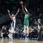 
              Boston Celtics guard Jaylen Brown (7) shoots a three-point shot over the defense of Orlando Magic guard Gary Harris (14) during the first half of an NBA basketball game, Sunday, Jan. 2, 2022, in Boston. (AP Photo/Mary Schwalm)
            