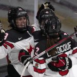 
              FILE - Canada's Marie-Philip Poulin, left, is congratulated by teammates Jocelyne Larocque (3) and Blayre Turnbull (40) after scoring the game-winning goal in overtime of a women's exhibition hockey game against the United States ahead of the Beijing Olympics, Dec. 15, 2021, in Maryland Heights, Mo. Poulin has been nicknamed `Captain Clutch' for an ability to score decisive goals on the world's biggest stage. (AP Photo/Jeff Roberson, File)
            