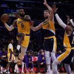 
              Los Angeles Lakers forward LeBron James (6) passes against Indiana Pacers forward Domantas Sabonis (11) and forward Oshae Brissett (12) during the first half of an NBA basketball game in Los Angeles, Wednesday, Jan. 19, 2022. (AP Photo/Ashley Landis)
            