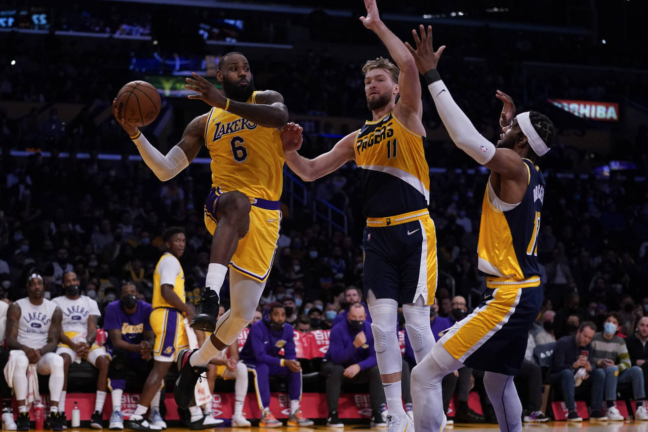 Los Angeles Lakers forward LeBron James (6) passes against Indiana Pacers forward Domantas Sabonis ...
