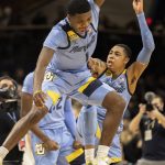 
              Marquette guard Kam Jones (1) celebrates with forward Olivier-Maxence Prosper (12) and guard Greg Elliott (5) after their team defeated Villanova in an NCAA college basketball game, Wednesday, Jan. 19, 2022, in Villanova, Pa. (AP Photo/Laurence Kesterson)
            