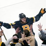 
              Boston Bruins right wing David Pastrnak celebrates with fans after his goal against the New Jersey Devils, which broke a 3-3 tie, during the third period of an NHL hockey game Tuesday, Jan. 4, 2022, in Boston. (AP Photo/Charles Krupa)
            