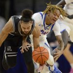 
              Providence's Jared Bynum (4) battles DePaul's Jalen Terry (3) for a loose ball during the first half of an NCAA college basketball game Saturday, Jan.1, 2022, in Chicago. (AP Photo/Paul Beaty)
            