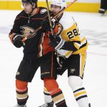 
              Anaheim Ducks center Derek Grant (38) and Pittsburgh Penguins defenseman Marcus Pettersson (28) battle for a position in the third period of an NHL hockey game in Anaheim, Calif., Tuesday, Jan. 11, 2022. (AP Photo/Kyusung Gong)
            