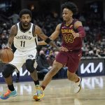 
              Brooklyn Nets' Kyrie Irving (11) drives against Cleveland Cavaliers' Isaac Okoro (35) in the second half of an NBA basketball game, Monday, Jan. 17, 2022, in Cleveland. (AP Photo/Tony Dejak)
            