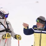 
              Kiana Kryeziu, left, listens to Kosovo's national team coach Agim Pupovci during training at the Arxhena Ski center in Dragas, Kosovo on Saturday, Jan. 22, 2022. The 17-year-old Kryeziu is the first female athlete from Kosovo at the Olympic Winter Games after she met the required standards, with the last races held in Italy. (AP Photo/Visar Kryeziu)
            
