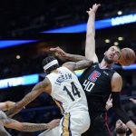 
              Los Angeles Clippers center Ivica Zubac (40) tries to block a pass by New Orleans Pelicans forward Brandon Ingram (14) in the first half of an NBA basketball game in New Orleans, Thursday, Jan. 13, 2022. (AP Photo/Gerald Herbert)
            