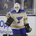
              St. Louis Blues goaltender Ville Husso stretches before the team's NHL Winter Classic hockey game against Minnesota Wild on Saturday, Jan. 1, 2022, in Minneapolis. (AP Photo/Andy Clayton-King)
            