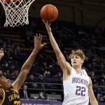 
              Washington's Cole Bajema (22) shoots over California's Andre Kelly, left, in the first half of an NCAA college basketball game Wednesday, Jan. 12, 2022, in Seattle. (AP Photo/Elaine Thompson)
            