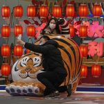 
              A couple wearing face masks to protect from the coronavirus take a selfie with a tiger decoration, a Chinese zodiac which marks the year 2022, at a shopping mall in Beijing, Sunday, Jan. 9, 2022. Tianjin, a major Chinese port city near the capital Beijing, began mass testing of its 14 million residents on Sunday, after a cluster of a dozen of children and adults tested positive for COVID-19, including a few with the omicron variant. (AP Photo/Andy Wong)
            