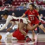 
              Boston College guard Marnelle Garraud (14) dives for a loose ball ahed of Louisville forward Emily Engstler and guard Chelsie Hall (23) during the first half of an NCAA college basketball game, Sunday, Jan. 16, 2022, in Boston. (AP Photo/Mary Schwalm)
            
