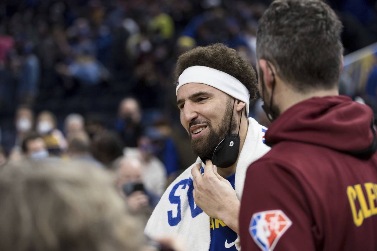 Golden State Warriors' Klay Thompson talks to players after an NBA basketball game against the Clev...