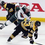 
              Minnesota Wild's Ryan Hartman (38) and Boston Bruins' Brad Marchand (63) collide during the second period of an NHL hockey game, Thursday, Jan. 6, 2022, in Boston. (AP Photo/Michael Dwyer)
            