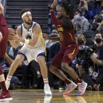 
              Golden State Warriors guard Klay Thompson, left, looks to pass the ball against Cleveland Cavaliers guard Darius Garland, right, during the first half of an NBA basketball game in San Francisco, Sunday, Jan. 9, 2022. (AP Photo/John Hefti)
            