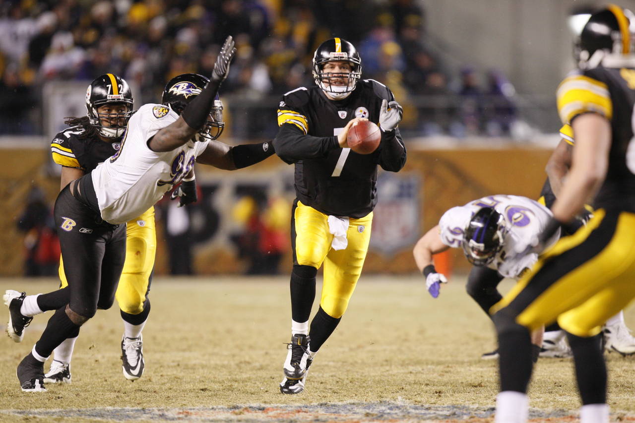 FILE - Pittsburgh Steelers' Ben Roethlisberger shovel passes the ball while being hit by Baltimore ...