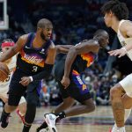 
              Phoenix Suns guard Chris Paul (3) moves the ball between New Orleans Pelicans guard Jose Alvarado (15) and New Orleans Pelicans center Jaxson Hayes in the second half of an NBA basketball game in New Orleans, Tuesday, Jan. 4, 2022. The Suns won 123-110. (AP Photo/Gerald Herbert)
            