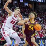 
              Minnesota's Sean Sutherlin (24) drives against Wisconsin's Chris Vogt (33) during the first half of an NCAA college basketball game Sunday, Jan. 30, 2022, in Madison, Wis. (AP Photo/Andy Manis)
            