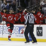 
              New Jersey Devils center Michael McLeod, left, celebrates after scoring a goal against the Carolina Hurricanes during the second period of an NHL hockey game, Saturday, Jan. 22, 2022, in Newark, N.J. (AP Photo/Noah K. Murray)
            