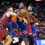 
              New York Knicks guard RJ Barrett (9) is fouled by Miami Heat guard Max Strus, left, during the first half of an NBA basketball game, Wednesday, Jan. 26, 2022, in Miami. (AP Photo/Lynne Sladky)
            