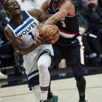 
              Minnesota Timberwolves forward Anthony Edwards, left, is fouled by Portland Trail Blazers guard CJ McCollum during the first half of an NBA basketball game in Portland, Ore., Tuesday, Jan. 25, 2022. (AP Photo/Craig Mitchelldyer)
            